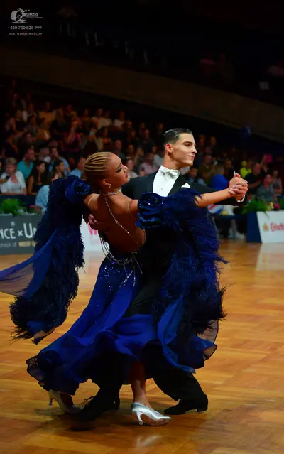 Dancesport competitor: Male dancer: black suit with a white shirt and white bow tie
