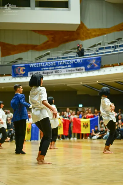 Dancesport competitor: Male dancer: blue patterned jacket and black trousers