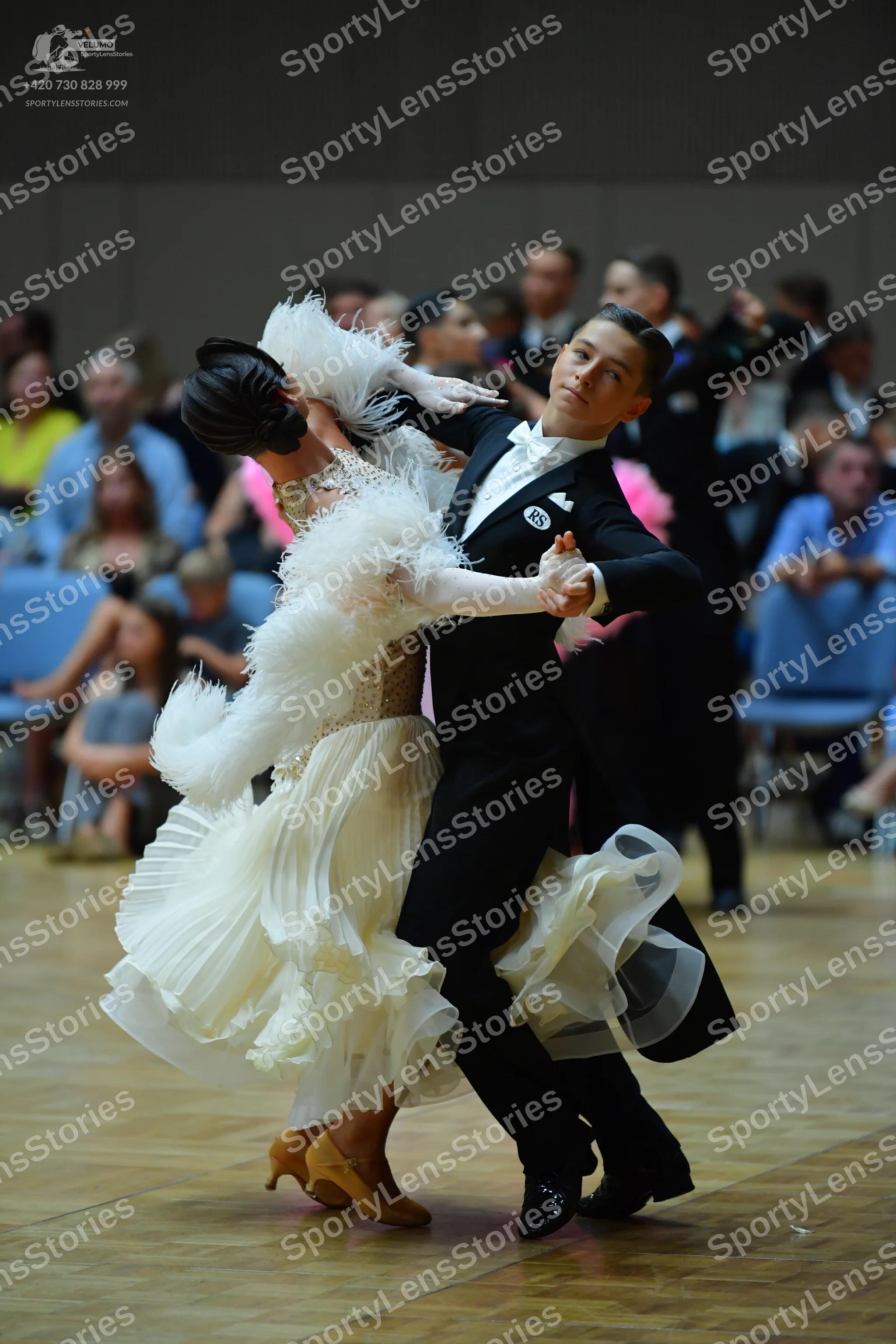 Dancesport competitor: Male dancer: black suit, white shirt, black bow tie, white pocket square, and bl