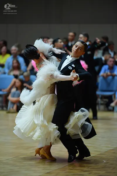 Dancesport competitor: Male dancer: black suit, white shirt, black bow tie, white pocket square, and bl