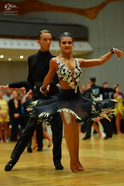 Dancesport competitor: Male dancer: black long-sleeved shirt and black trousers
