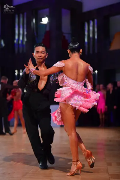 Dancesport competitor: Male dancer: black latin dance shirt with silver sequin embellishments on the cu