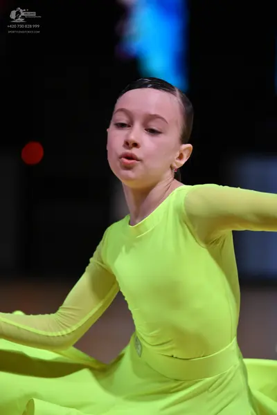 Dancesport competitor: Female dancer: bright lime green long-sleeved ballroom dress made of a smooth, s