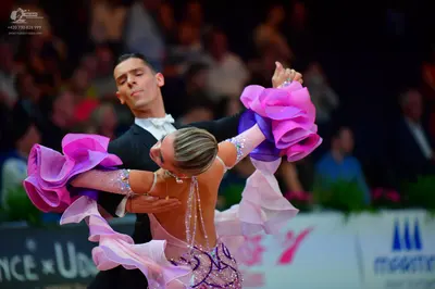 Dancesport competitor: Male dancer: black suit with a white shirt and white bow tie
