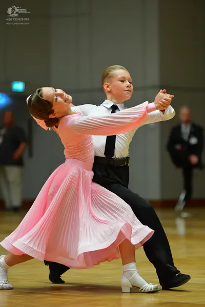 Dancesport competitor: Female dancer: light pink long-sleeved dance dress with a pleated skirt