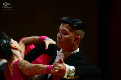 Dancesport competitor: Male dancer: black suit, white shirt, and white bow tie