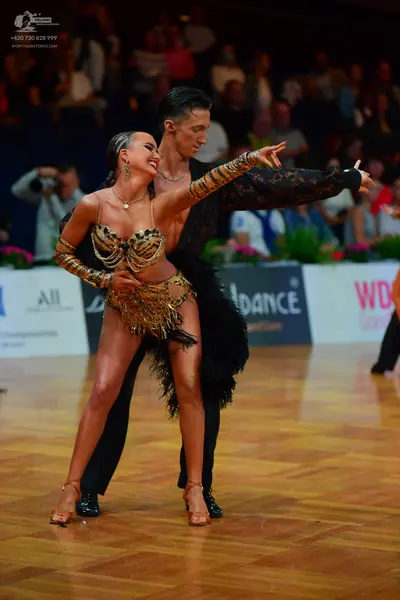 Dancesport competitor: Male dancer: black patterned long-sleeve shirt and black trousers