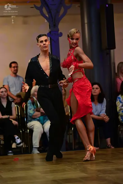 Dancesport competitor: Male dancer: black long-sleeved shirt and black trousers
