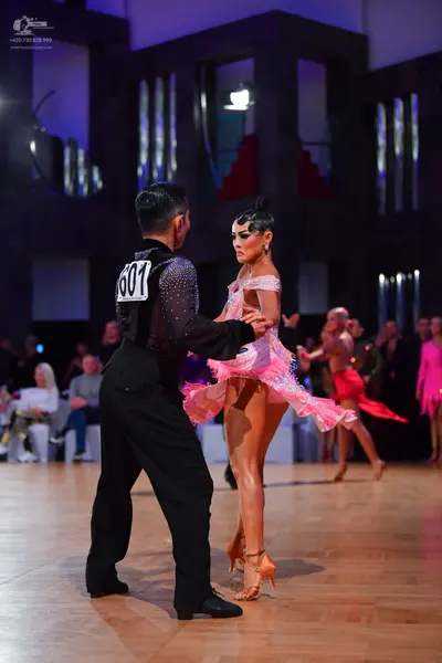 Dancesport competitor #601: Male dancer: black Latin dance shirt with silver/sparkly embellishments and blac