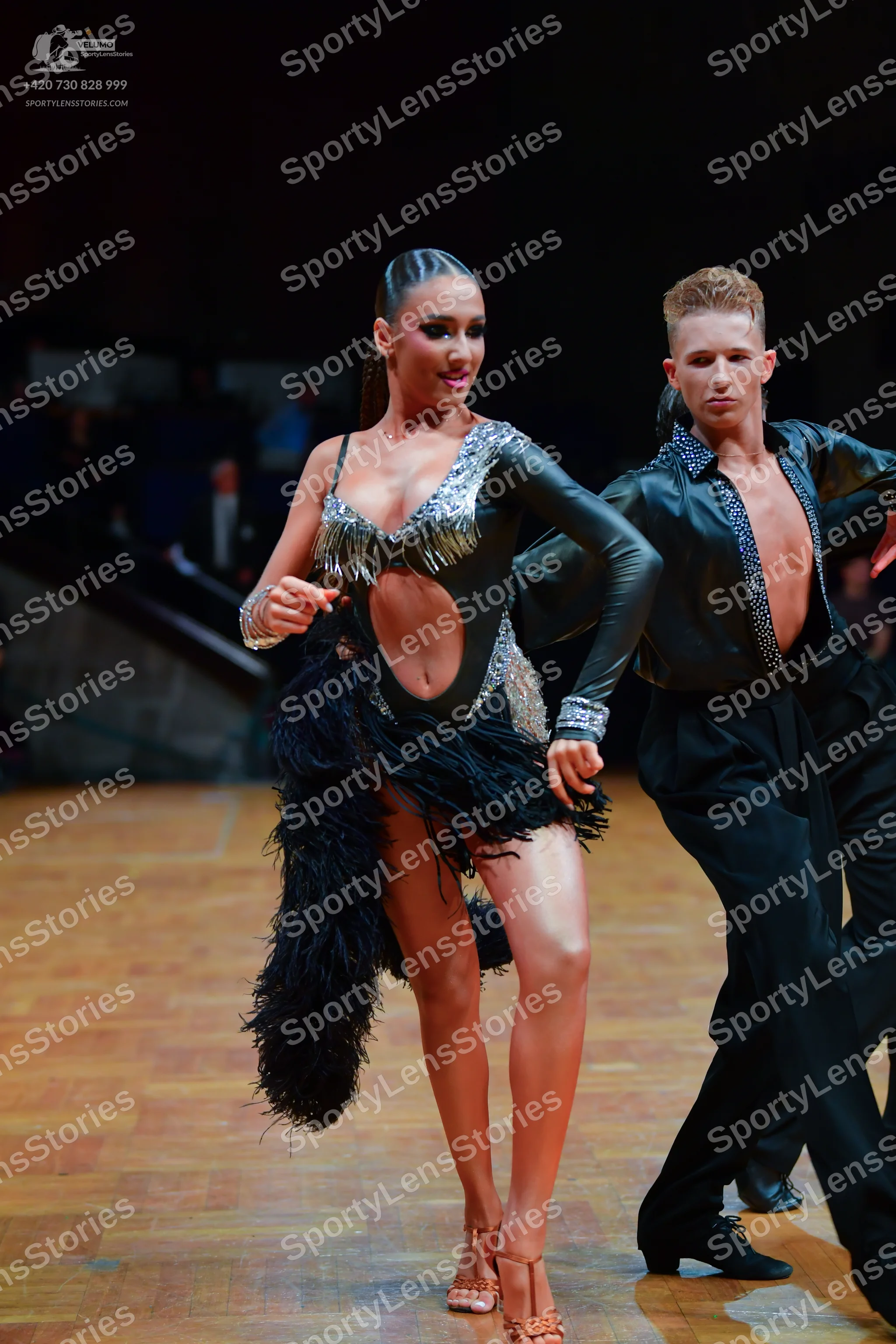 Dancesport competitor: Female dancer: black Latin dance costume with long sleeves, silver sequin embell