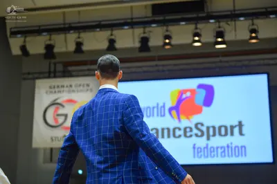Dancesport competitor: Male dancer: blue suit with a light-colored windowpane pattern