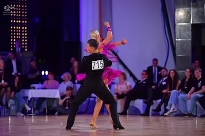 Dancesport competitor #715: Male dancer: black long-sleeved shirt and black trousers