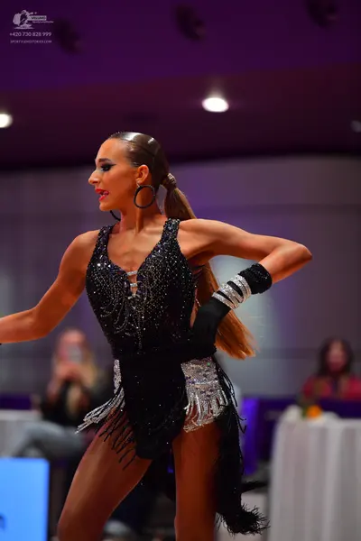 Dancesport competitor: Female dancer: black latin dress with silver sequin embellishments and silver fr