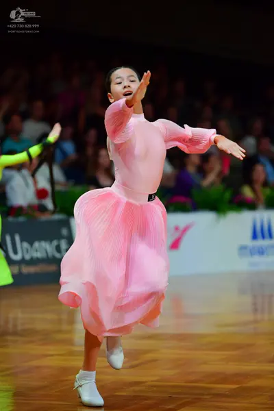 Dancesport competitor: Female dancer: light pink long-sleeved dress with a pleated skirt and sleeves