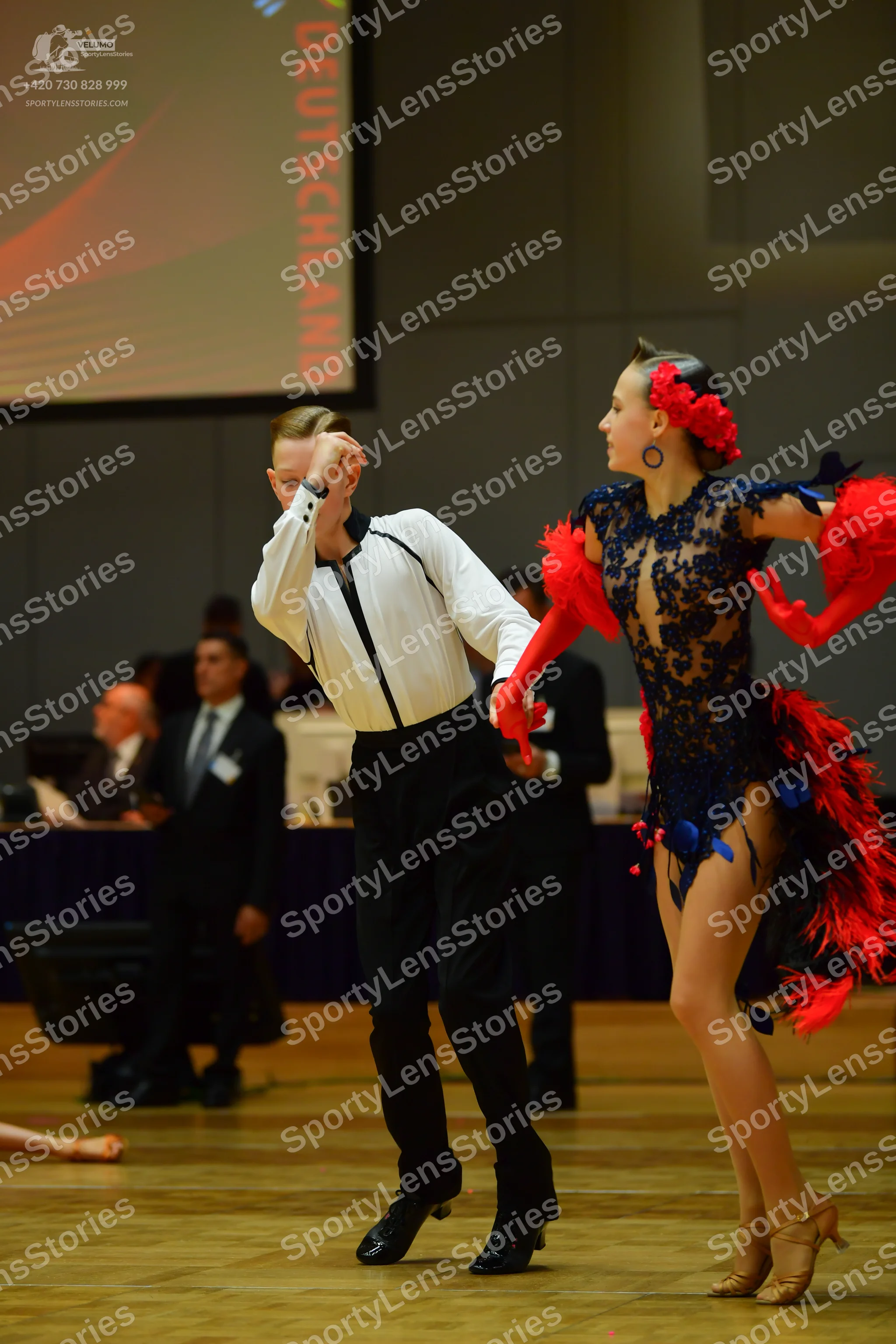 Dancesport competitor: Male dancer: white long-sleeved shirt with black trim and black trousers