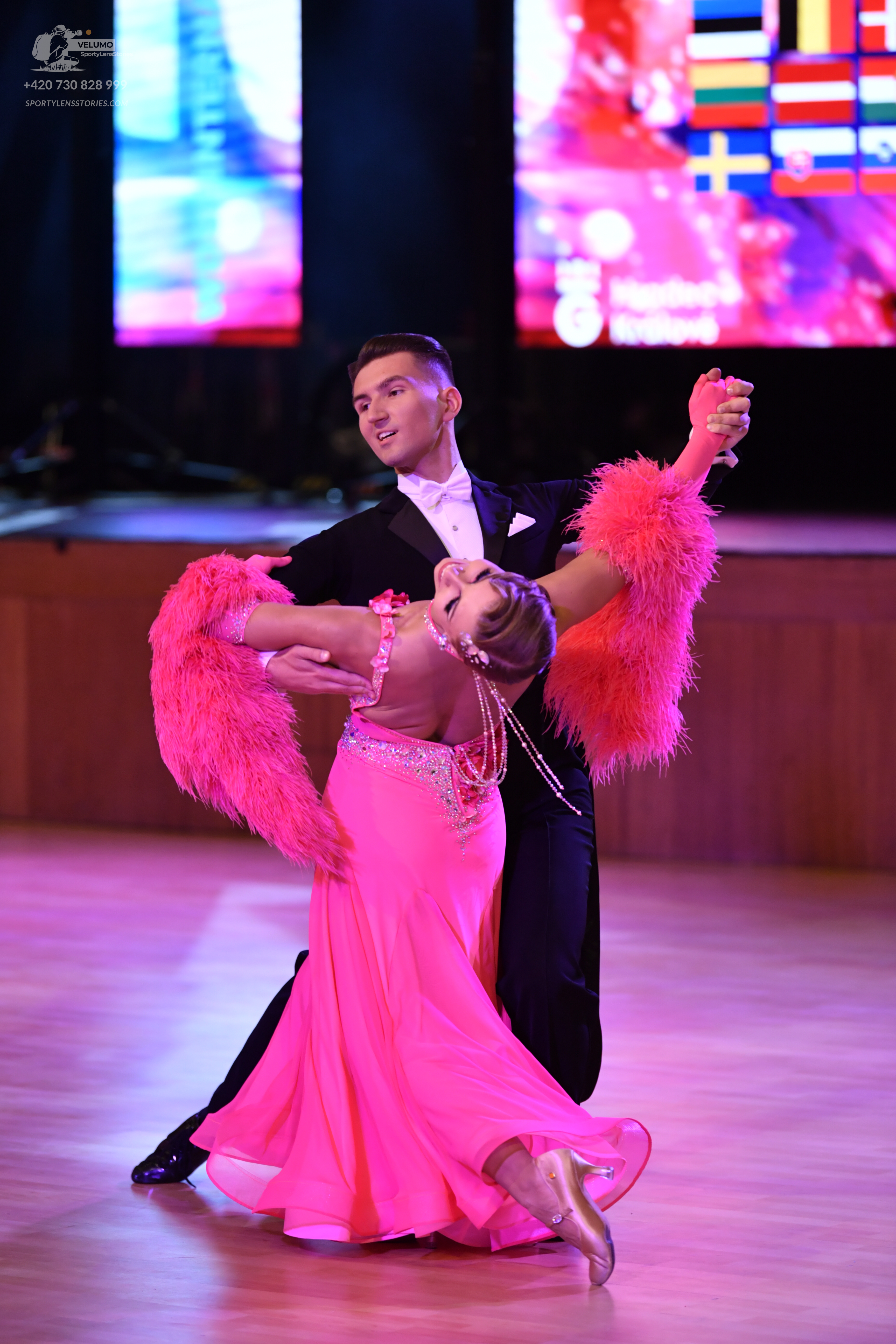 Dancesport competitor: Male dancer: black suit with a white shirt and white pocket square