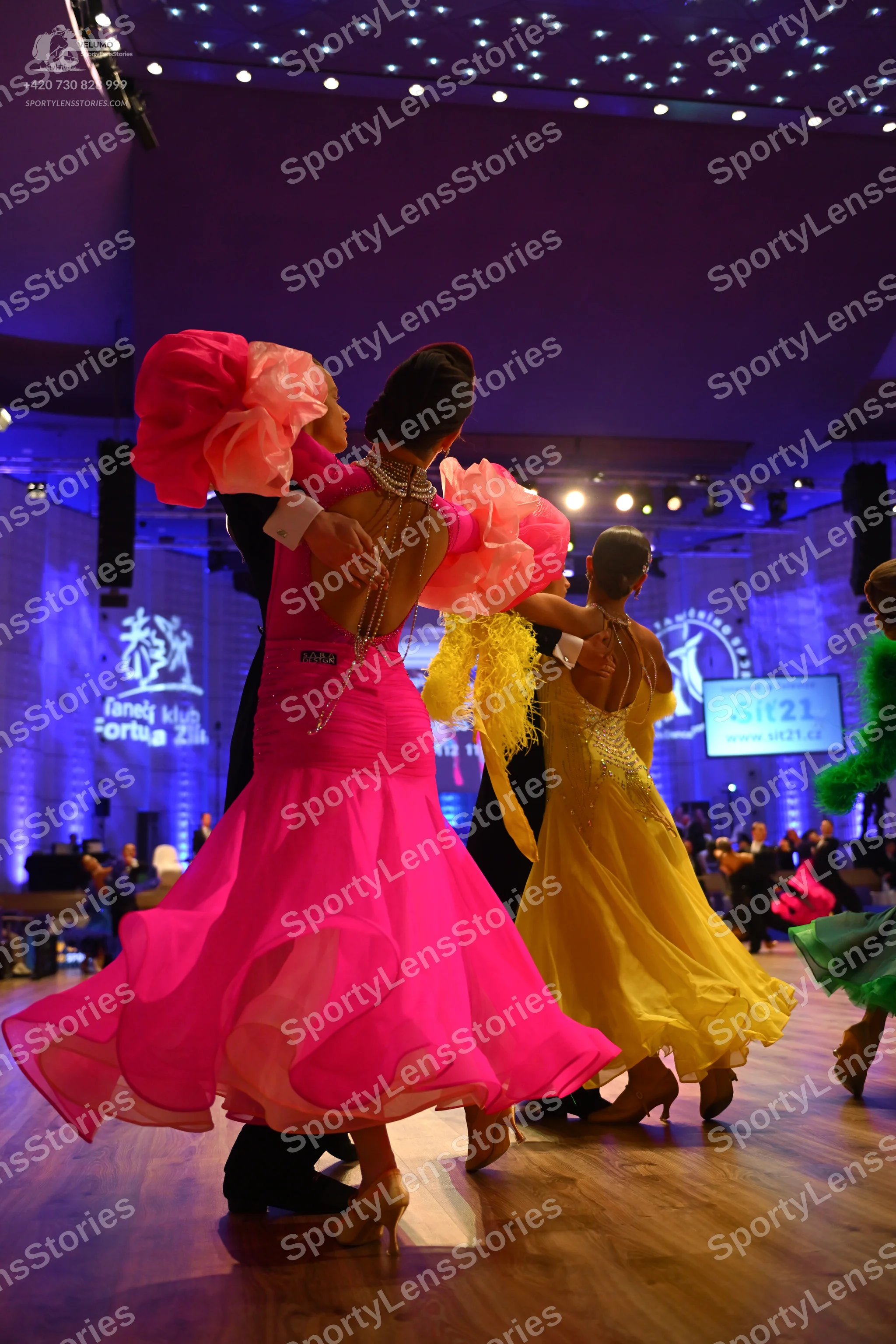 Dancesport competitor: Female dancer 1: pink ballgown with voluminous, ruffled sheer pink sleeves and a