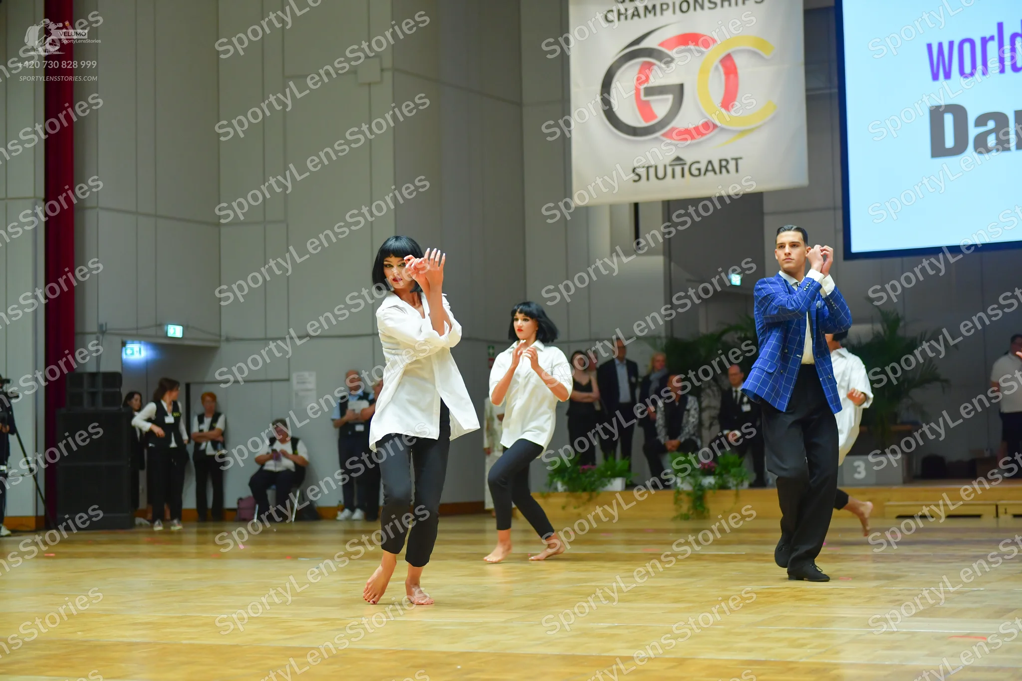 Dancesport competitor: Female dancer 1: white long-sleeved button-down shirt and black leggings