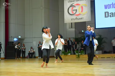 Dancesport competitor: Female dancer 1: white long-sleeved button-down shirt and black leggings