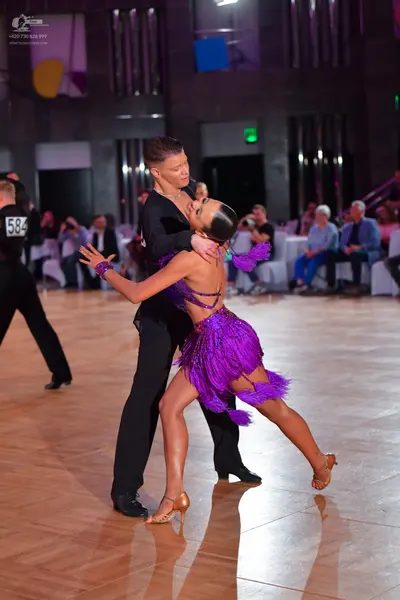 Dancesport competitor #584: Male dancer: black long-sleeved shirt and black trousers