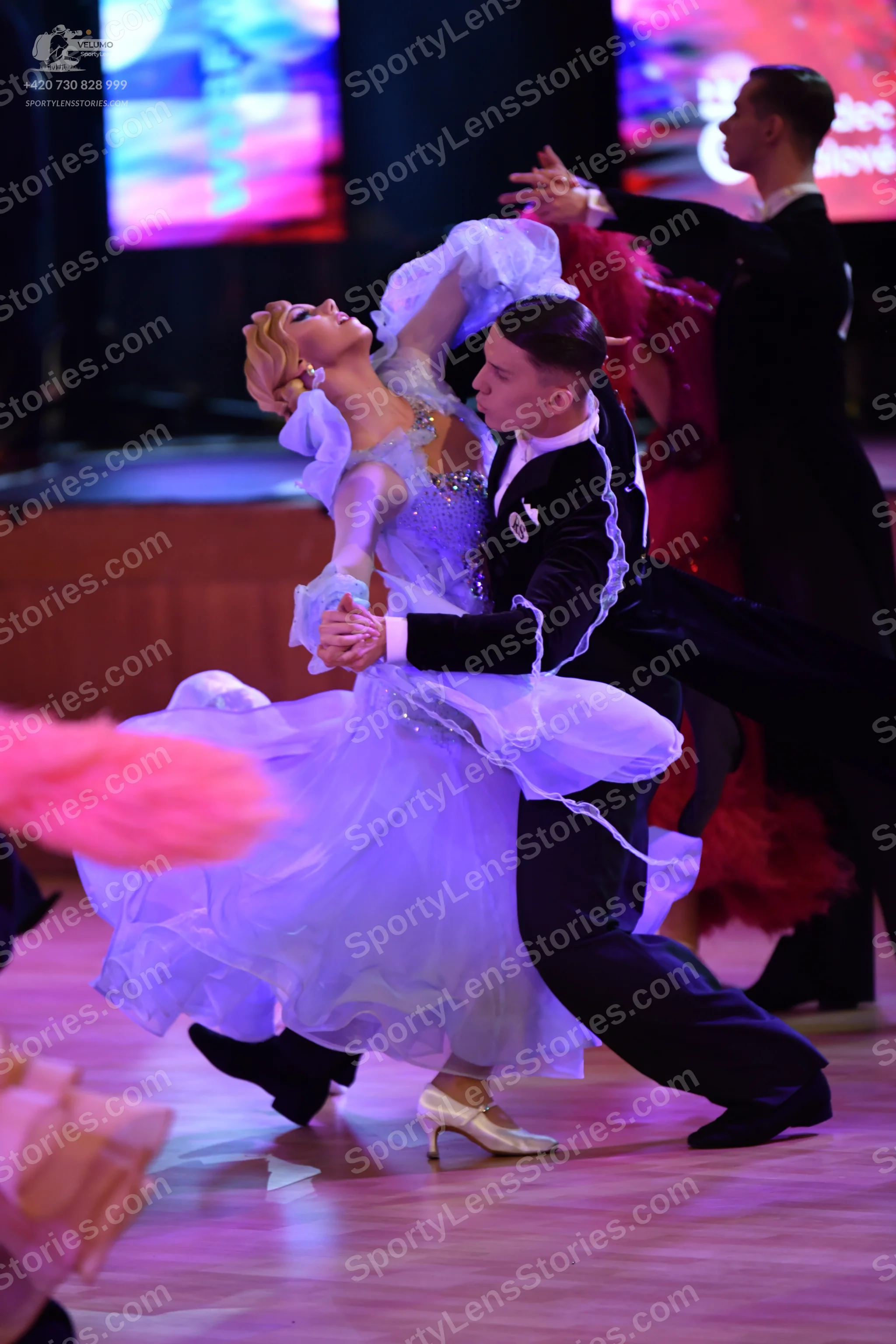 Dancesport competitor: Female dancer: light blue voluminous ballgown with layered, ruffled tulle or org