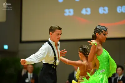 Dancesport competitor: Male dancer: white long-sleeved shirt with black suspenders and black trousers
