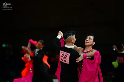 Dancesport competitor #55, #23: Male dancer (foreground): black long-sleeved top