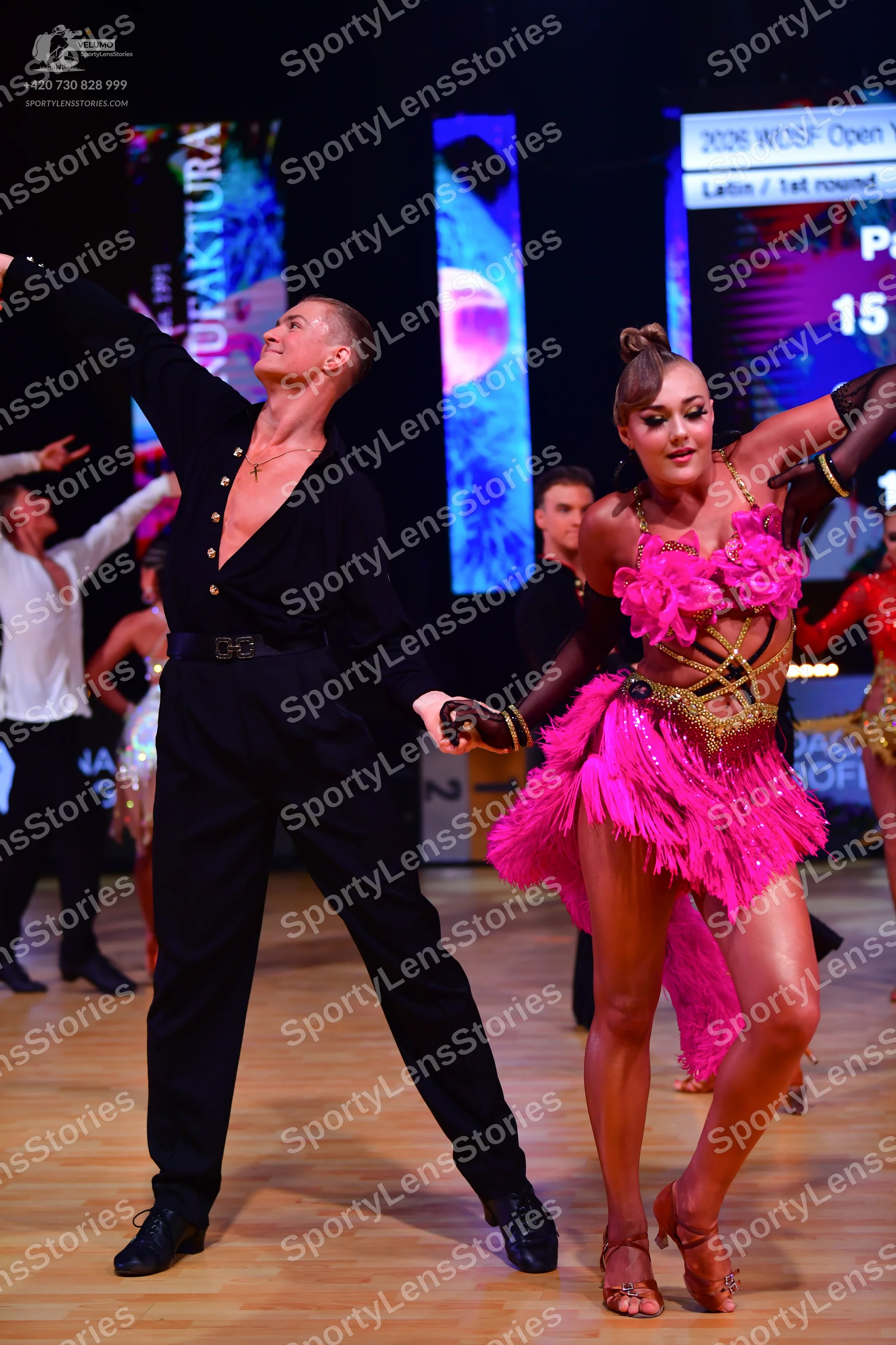 Dancesport competitor: Male dancer: black long-sleeved shirt with a deep V-neck and black trousers