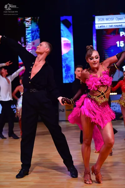 Dancesport competitor: Male dancer: black long-sleeved shirt with a deep V-neck and black trousers