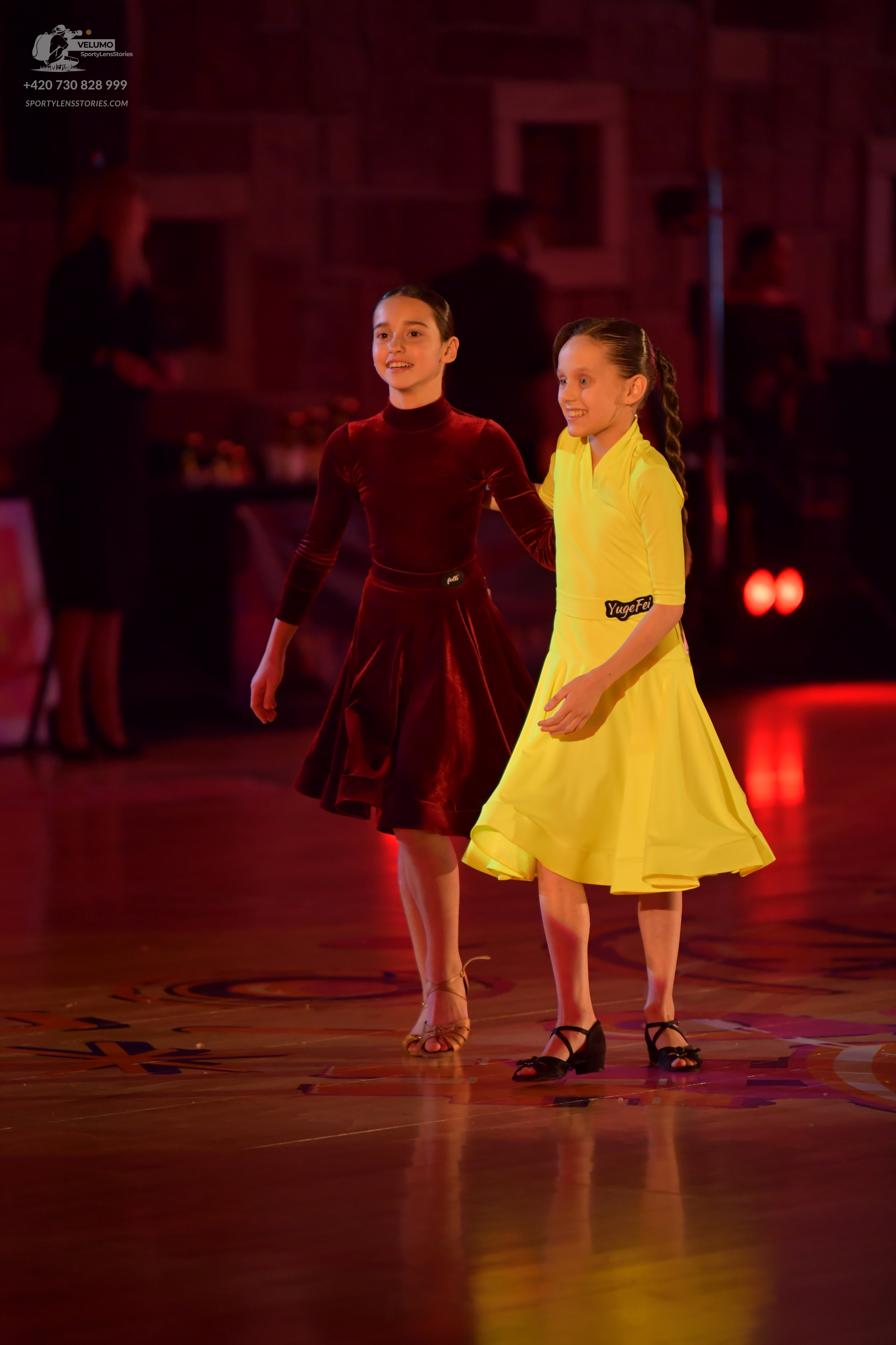 Dancesport competitor: Female dancer 1: burgundy long-sleeved dress with a flared skirt