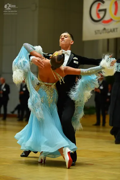 Dancesport competitor: Male dancer: black suit with a white shirt and white bowtie