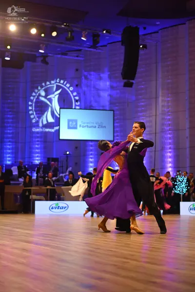 Dancesport competitor: Male dancer: black ballroom suit with a white shirt and black bow tie