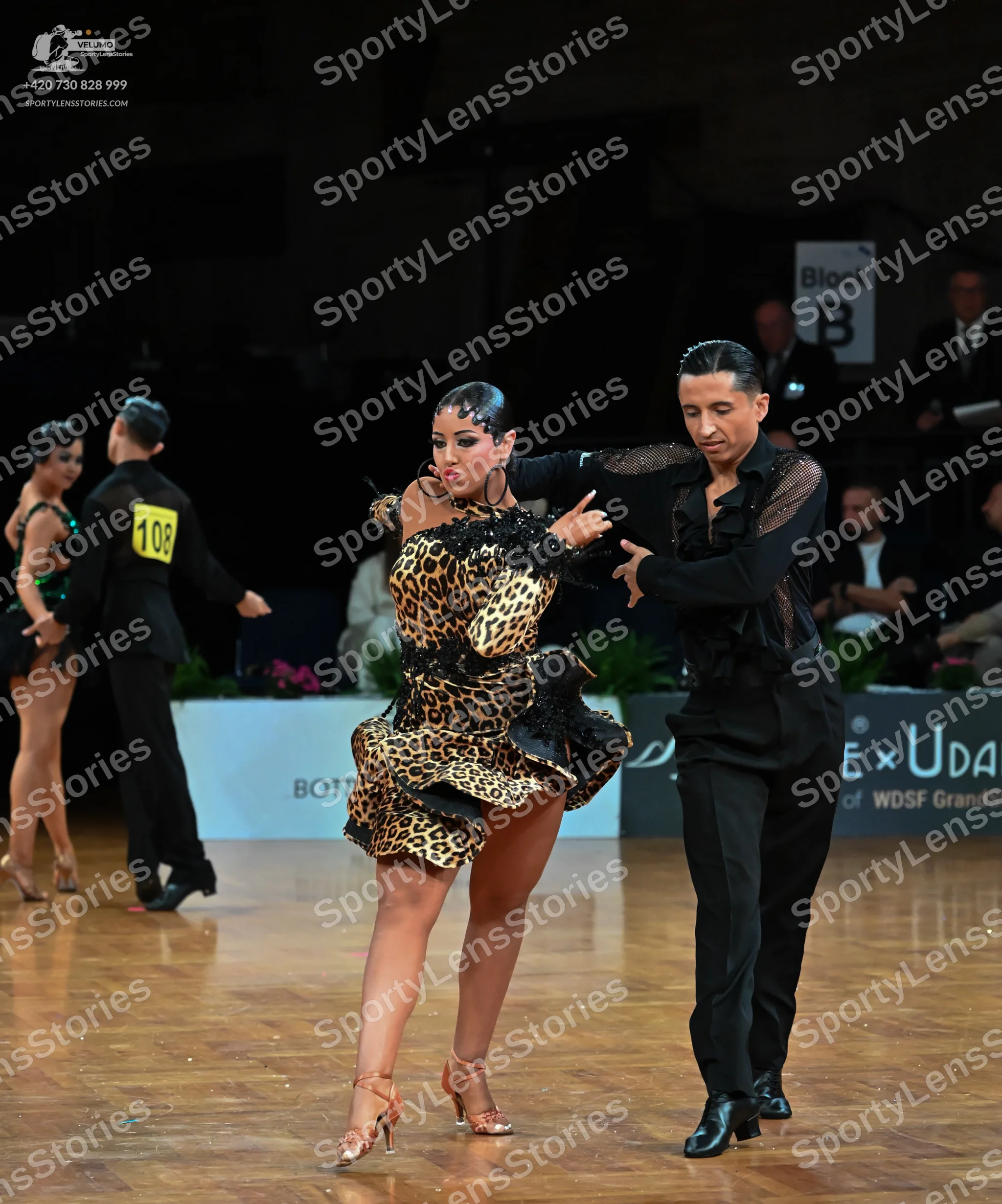 Dancesport competitor: Main female dancer: leopard print latin dress with ruffles