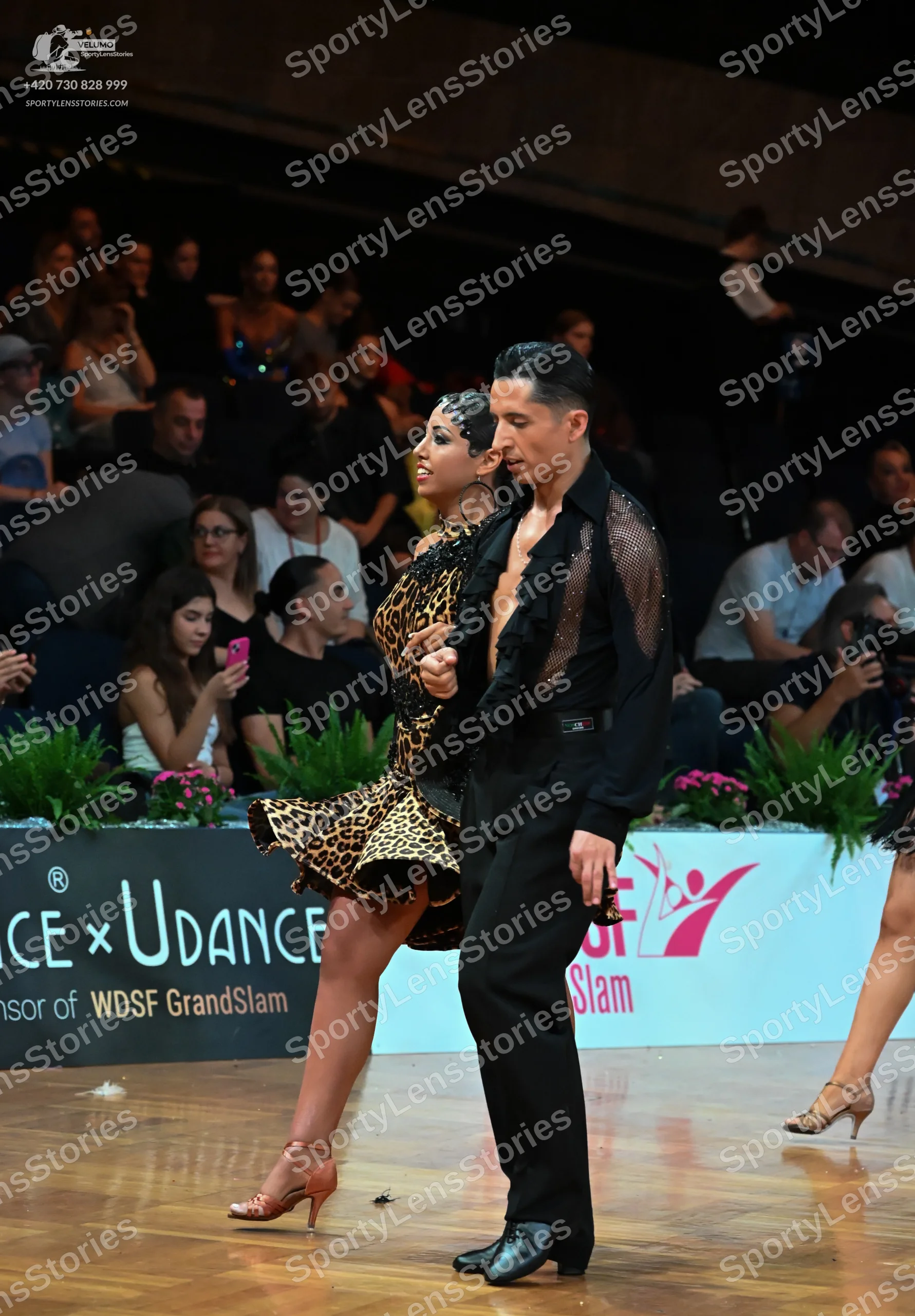 Dancesport competitor: Male dancer: black shirt with sheer, ruffled texture on the upper part and black