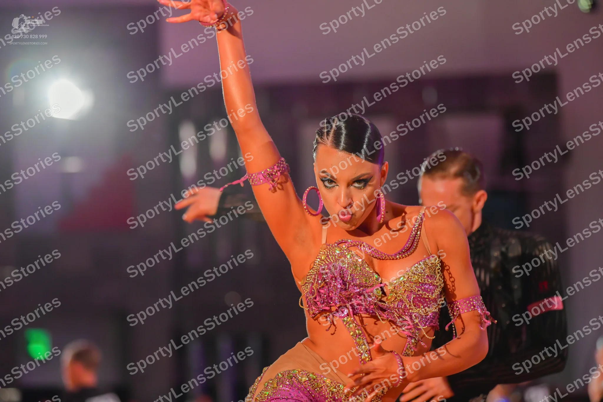 Dancesport competitor: Male dancer: black suit jacket with a pink/magenta design on the sleeve