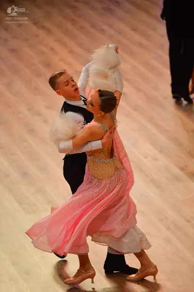 Dancesport competitor: Male dancer: black waistcoat over a white shirt