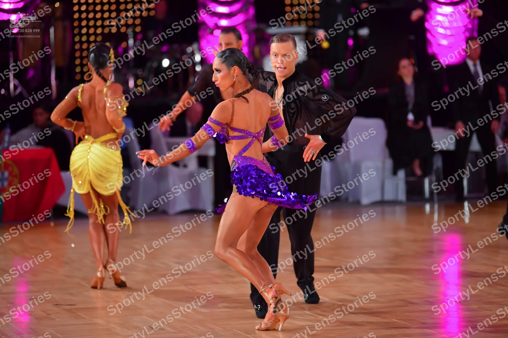 Dancesport competitor: Female dancer (left): yellow Latin dance dress with fringe
