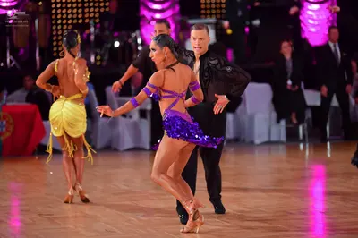 Dancesport competitor: Female dancer (left): yellow Latin dance dress with fringe
