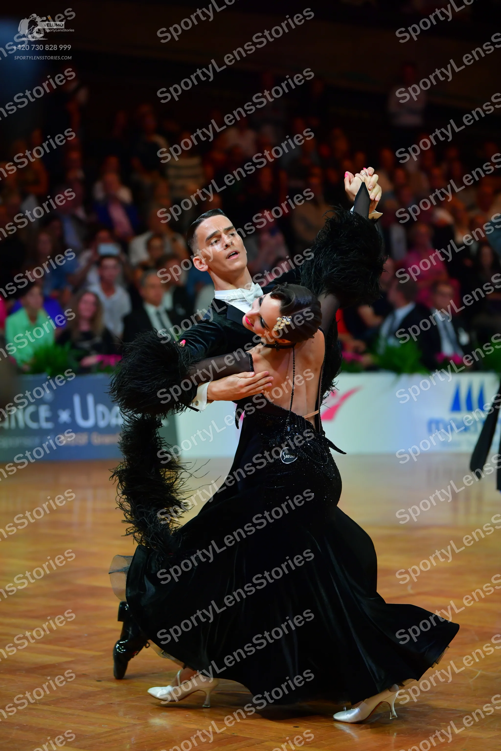 Dancesport competitor: Male dancer: black suit with a white shirt and white bow tie