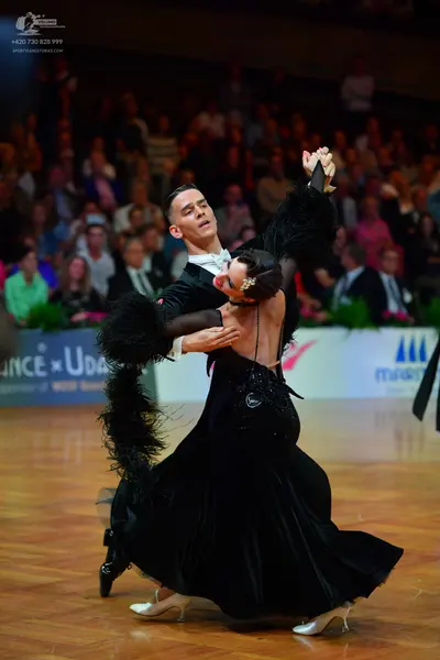 Dancesport competitor: Male dancer: black suit with a white shirt and white bow tie