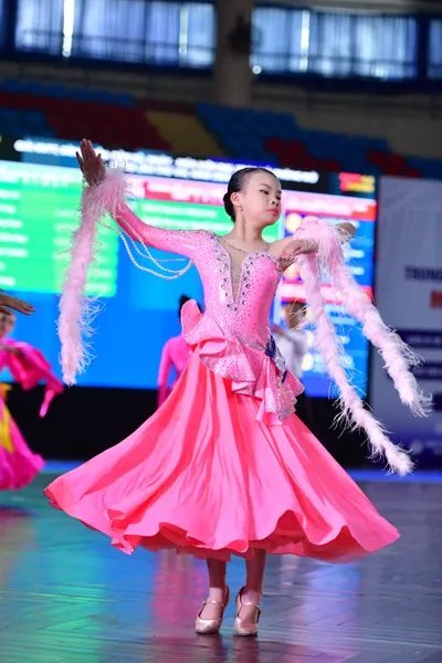 Dancesport competitor: ** Female: A stunning pink ballroom gown