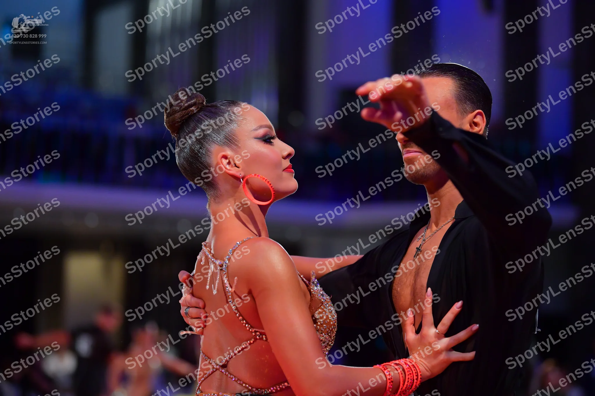 Dancesport competitor: Female dancer: tan-colored Latin dress with intricate sequin and bead embellishm