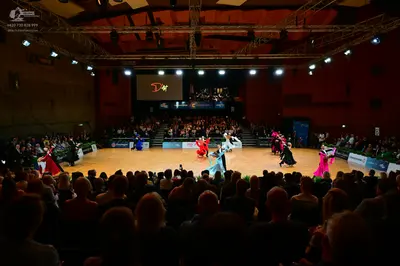 Dancesport competitor: Female dancer: bright red latin-style dress