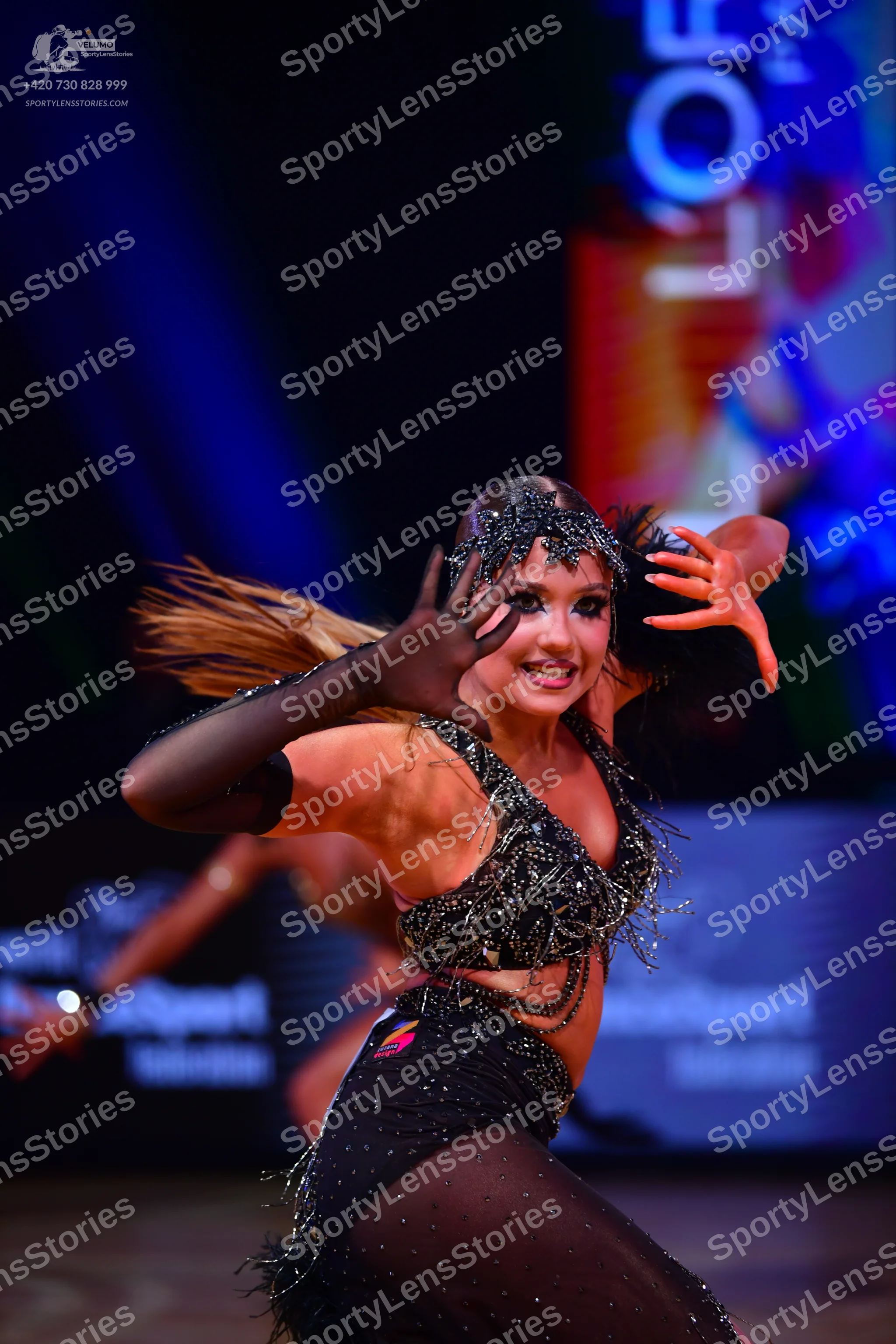 Dancesport competitor: Female dancer: black Latin dance costume decorated with sequins and beads, featu