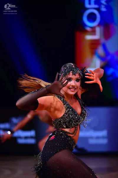 Dancesport competitor: Female dancer: black Latin dance costume decorated with sequins and beads, featu