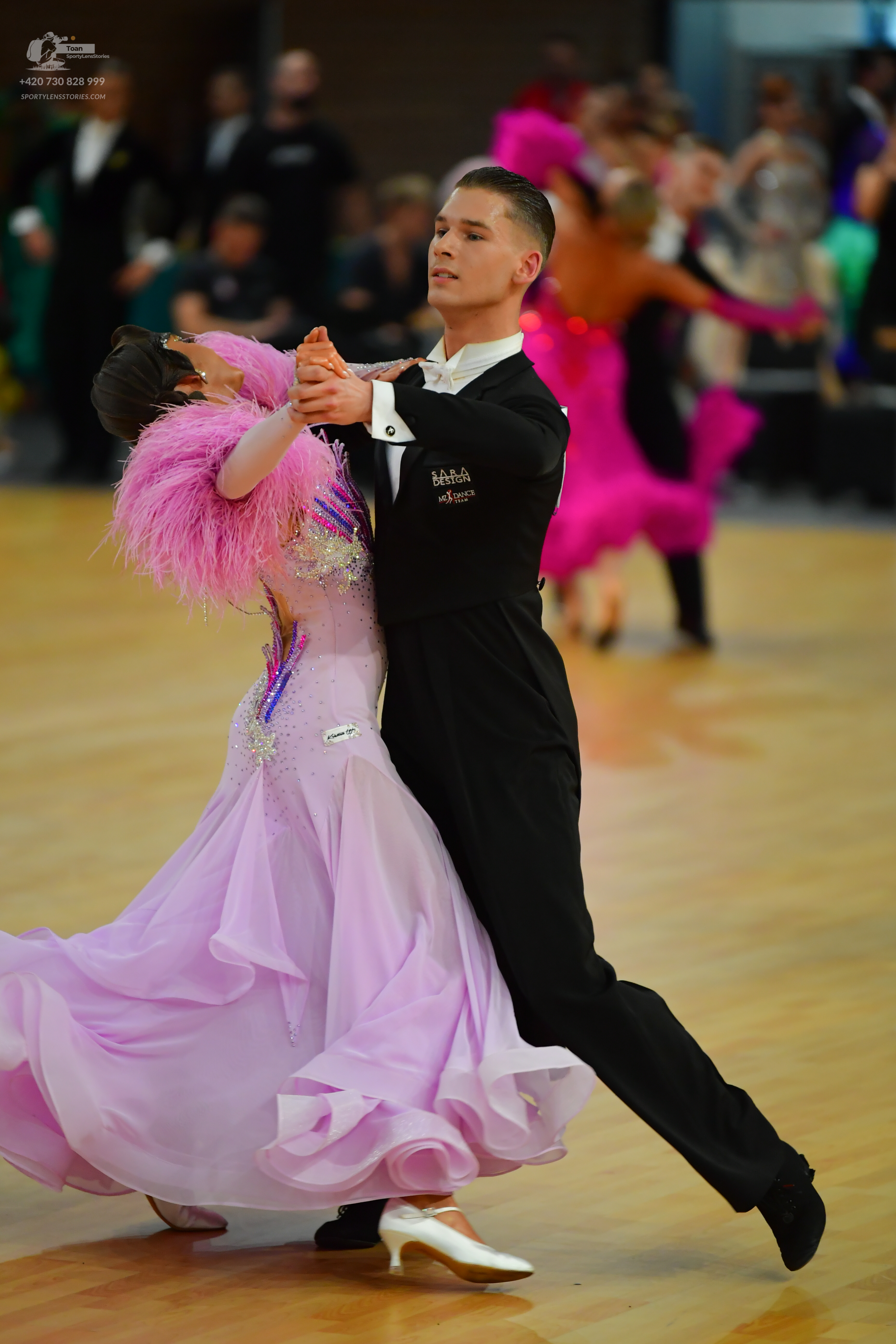 Dancesport competitor: ** Black tail suit with silver sequin lapels and matching trousers
