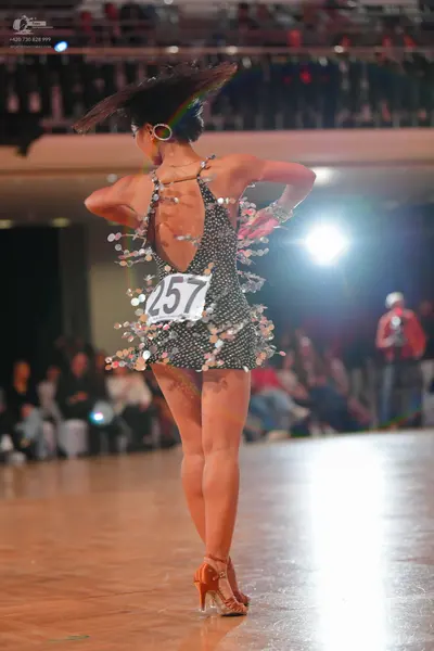Dancesport competitor #257: Female dancer: black sequined Latin dress with large silver sequins at the hem a