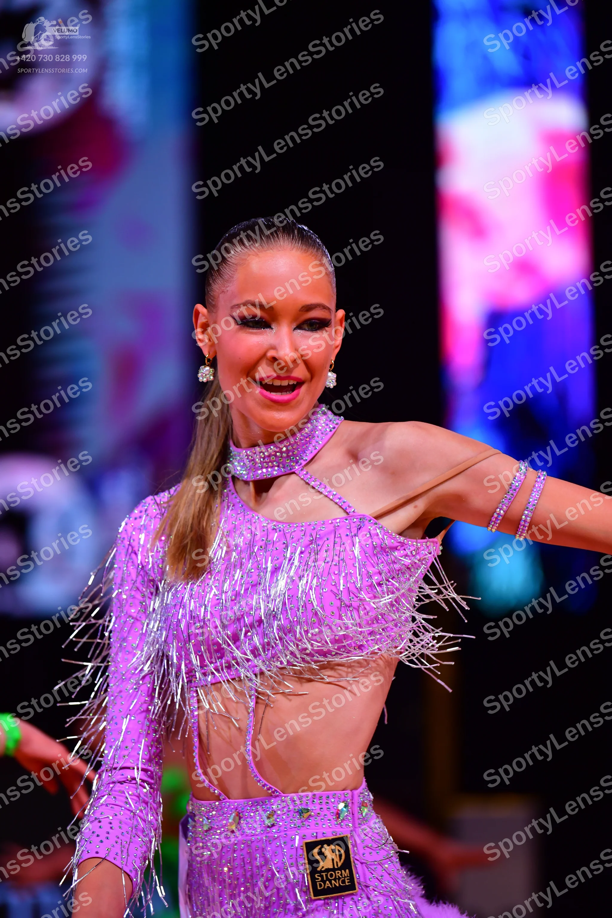 Dancesport competitor: Female dancer: light purple Latin dance costume with sequins and long silver fri