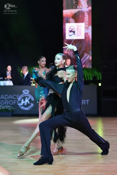 Dancesport competitor: Male dancer: black long-sleeved shirt and black trousers