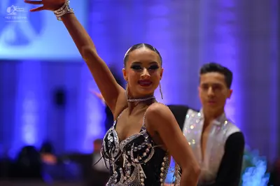 Dancesport competitor: Male dancer: black and white Latin dance shirt with a white, possibly sequined, 